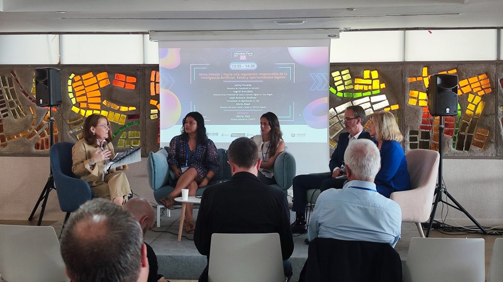 Panel on responsible AI regulation at OktoberTech 2025, moderated by Gloria Díaz (CONETIC)